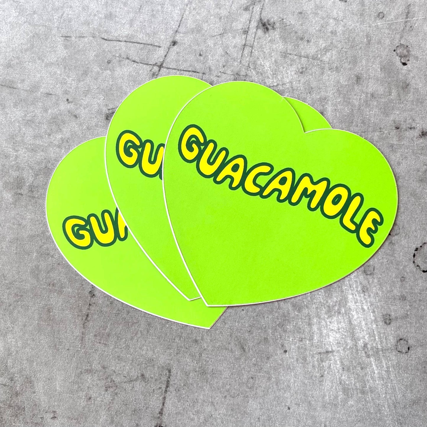 Three Guacamole Stickers shown in a pile.