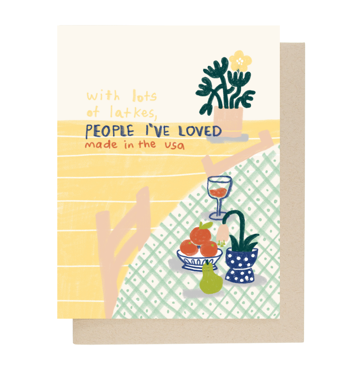 A greeting card with a light brown envelope behind it. The card features a retro-style illustration with the text 'with lots of latkes, PEOPLE I'VE LOVED made in the usa' above a stylized scene of a table filled with potted plants, fruit, and a patterned tablecloth.