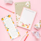 Before Happy Hour Notepad shown next to other types of notepads, with pink and white pencils on the side.