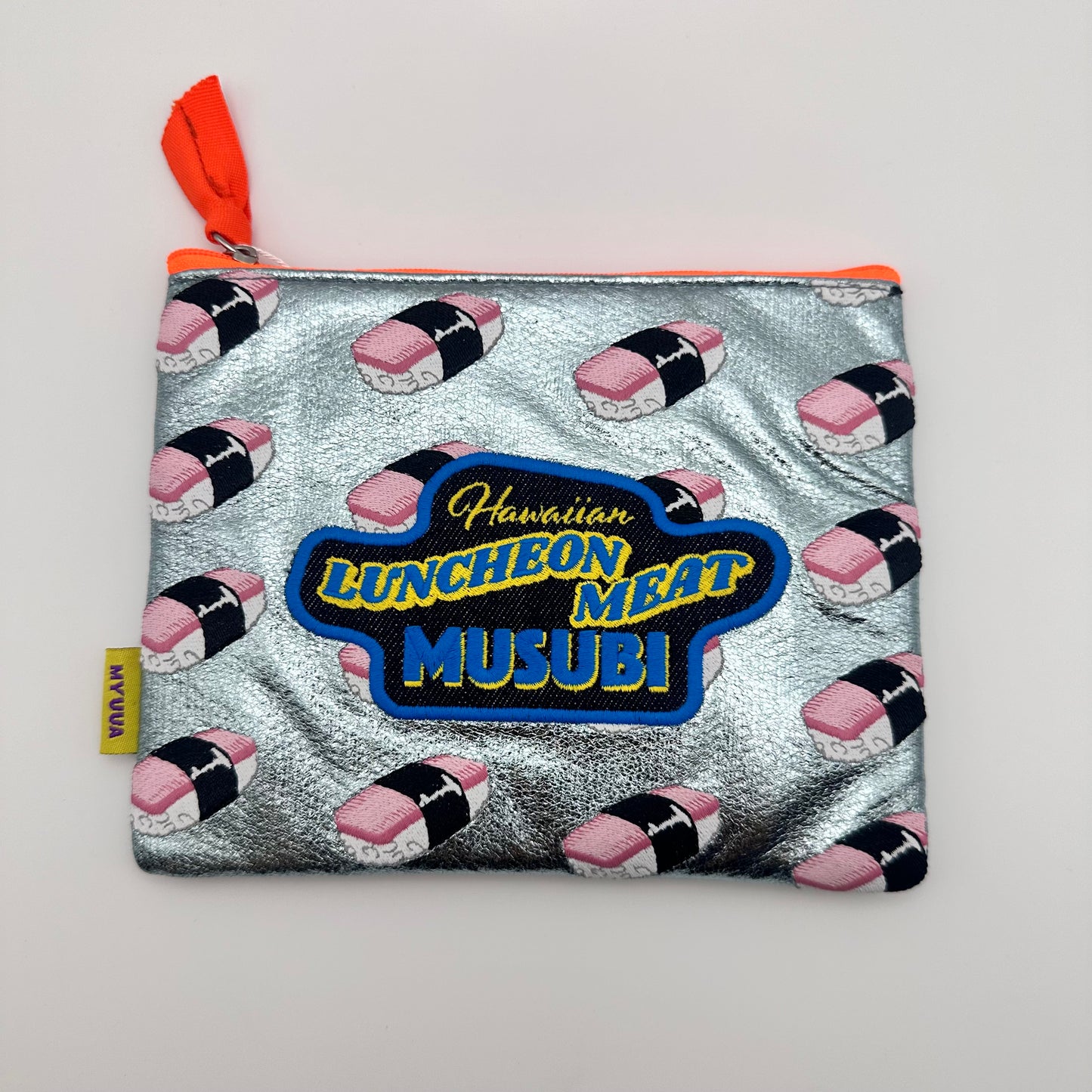 Silver bag with orange zipper. Bag has a pattern of embroidered Spam Musubi on the front with the words Hawaiian Luncheon Meat Musubi.