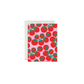 A greeting card with a repeating pattern of red tomatoes on a light pink background, shown with a white envelope behind it on a plain white background.