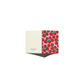 A folded greeting card shown open against a plain white background. The left panel is a warm cream color with small black text, and the right panel features a repeating pattern of red tomatoes with green stems on a light pink background.