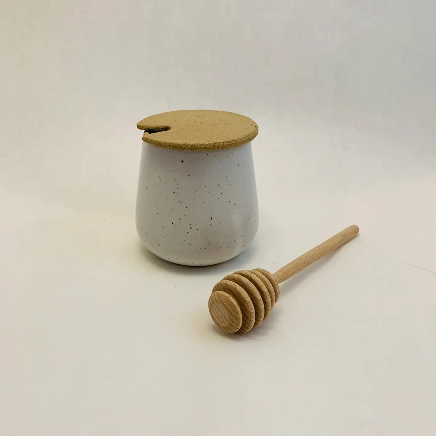 Ceramic honey jar and dipper -- glazed pot in speckled white, unglazed lid 