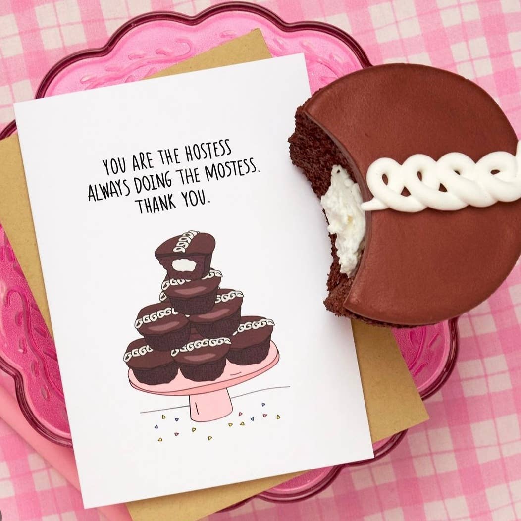 greeting card that reads "You are the hostess always doing the mostess. Thank you." and has a pyramid pile up of hostess cupcakes on a cake stand