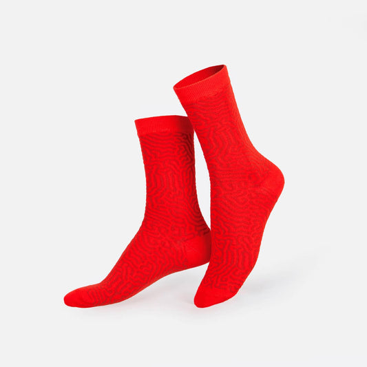 Pair of red textured socks on a white background