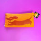 orange pouch with dachsund design on a purple background