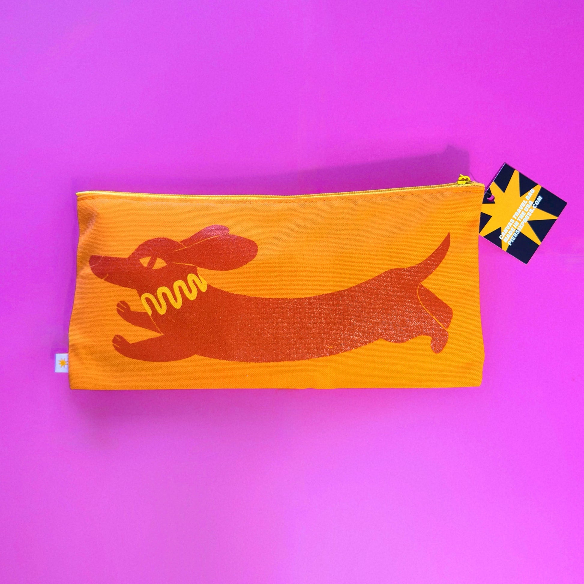 orange pouch with dachsund design on a purple background