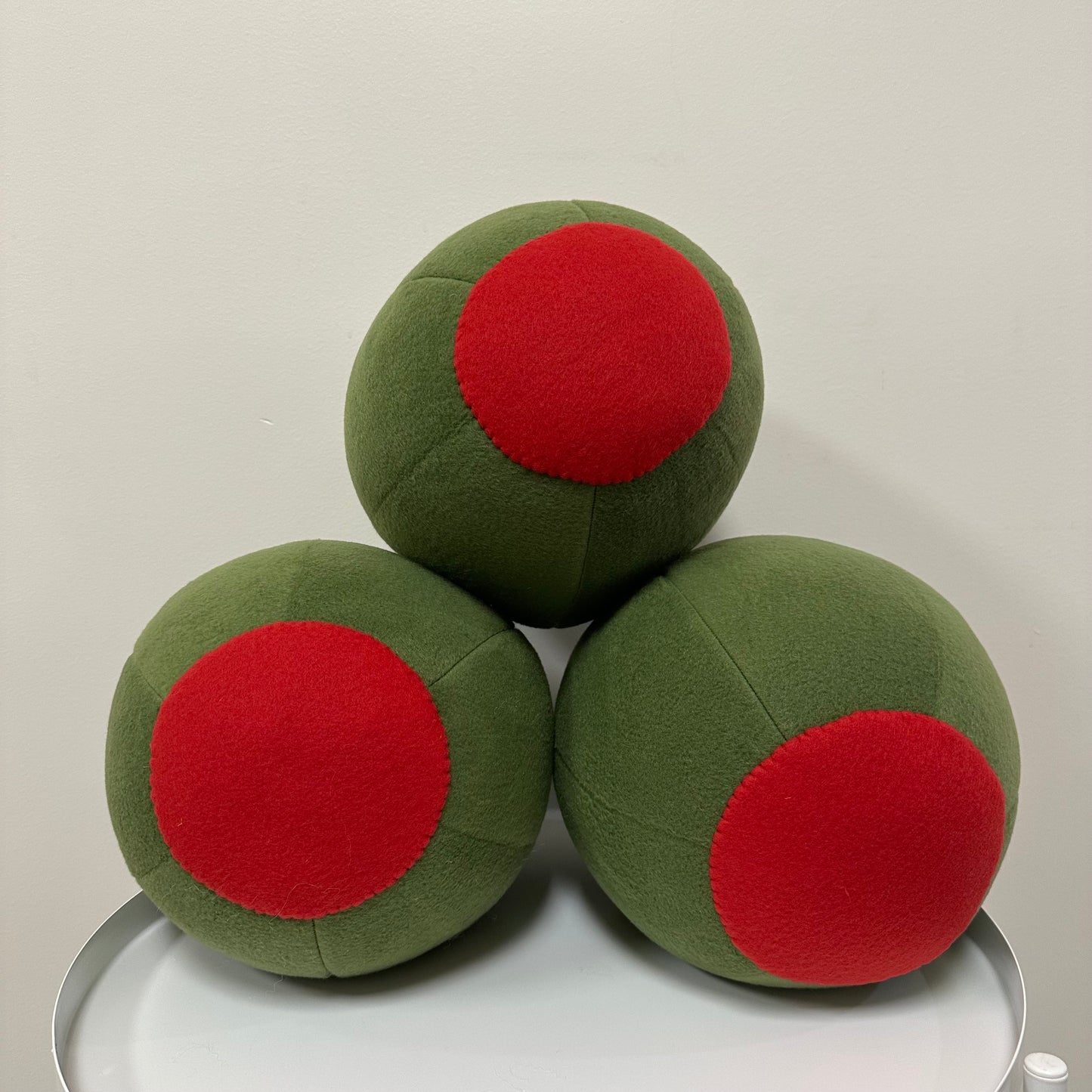 Three green olive pillows with pimento side showing.