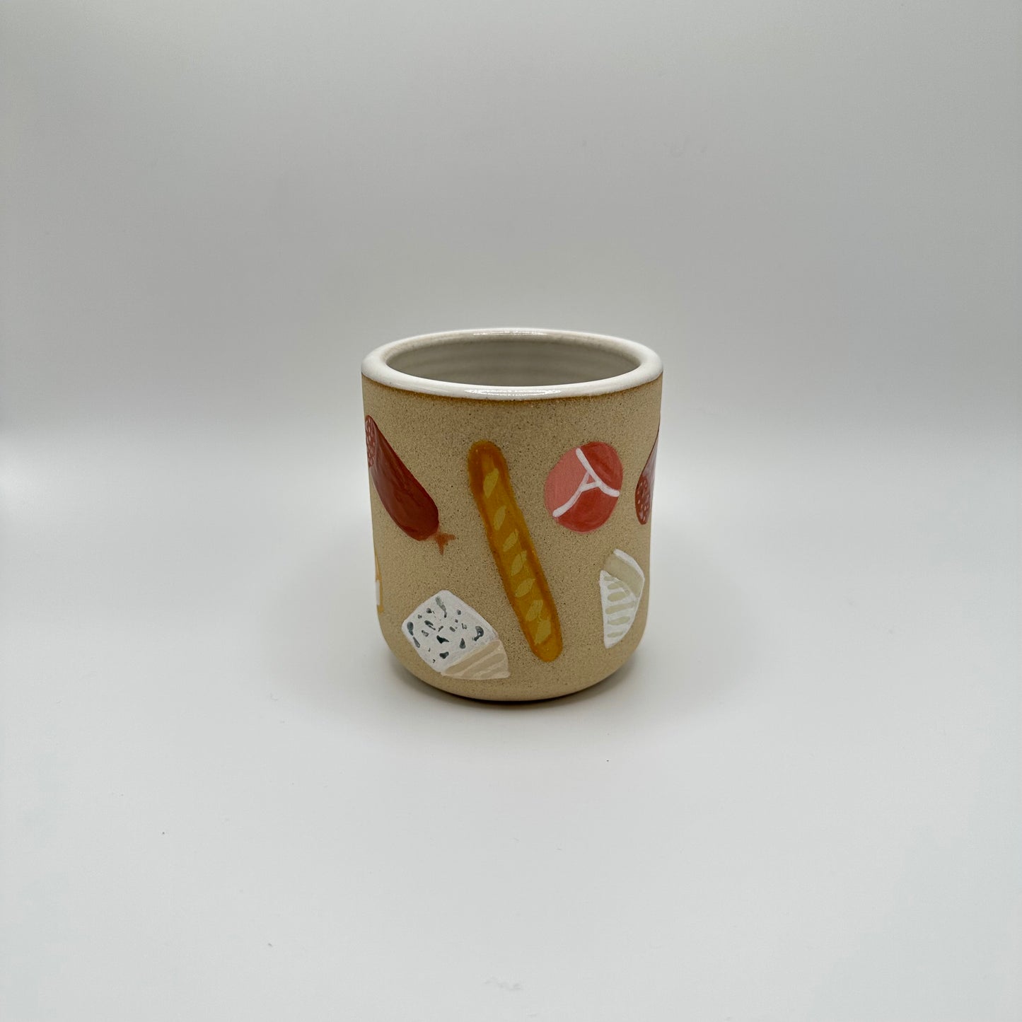 Cheese & Charcuterie Tumbler has an assortment of cheeses, meats and baguettes in various shapes, sizes and cuts.