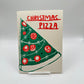 Card with a Christmas tree that also kinda looks like a pizza. The card reads: CHRISTMAS PIZZA