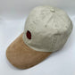 Beige Hat with suede-looking khaki bill. Canelê pastry embroidered on the top.