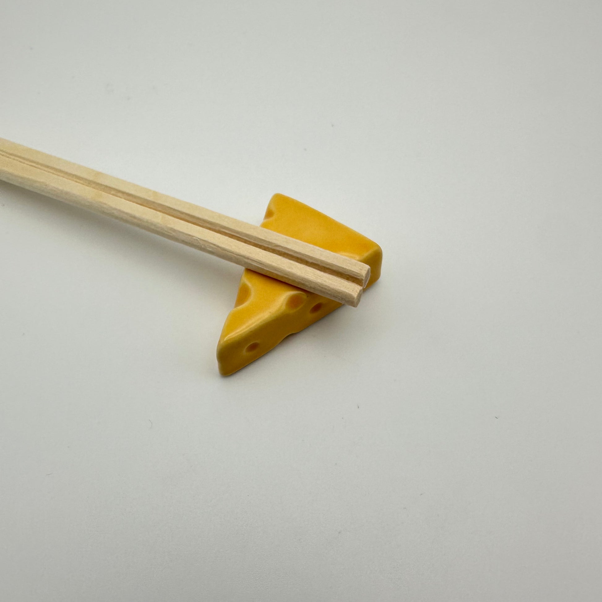 cheese chopstick holder with chopsticks