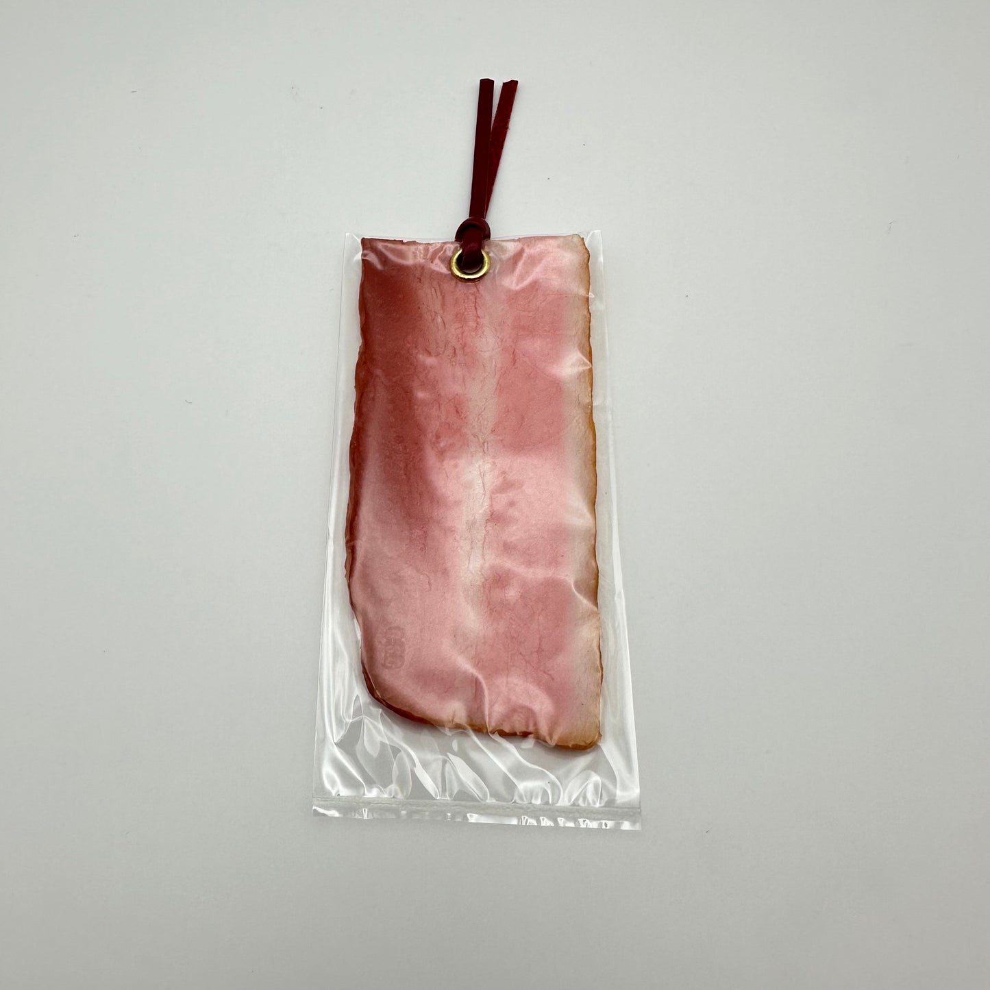 Bookmark made to look like real bacon. Complete with gromit and leather strap.