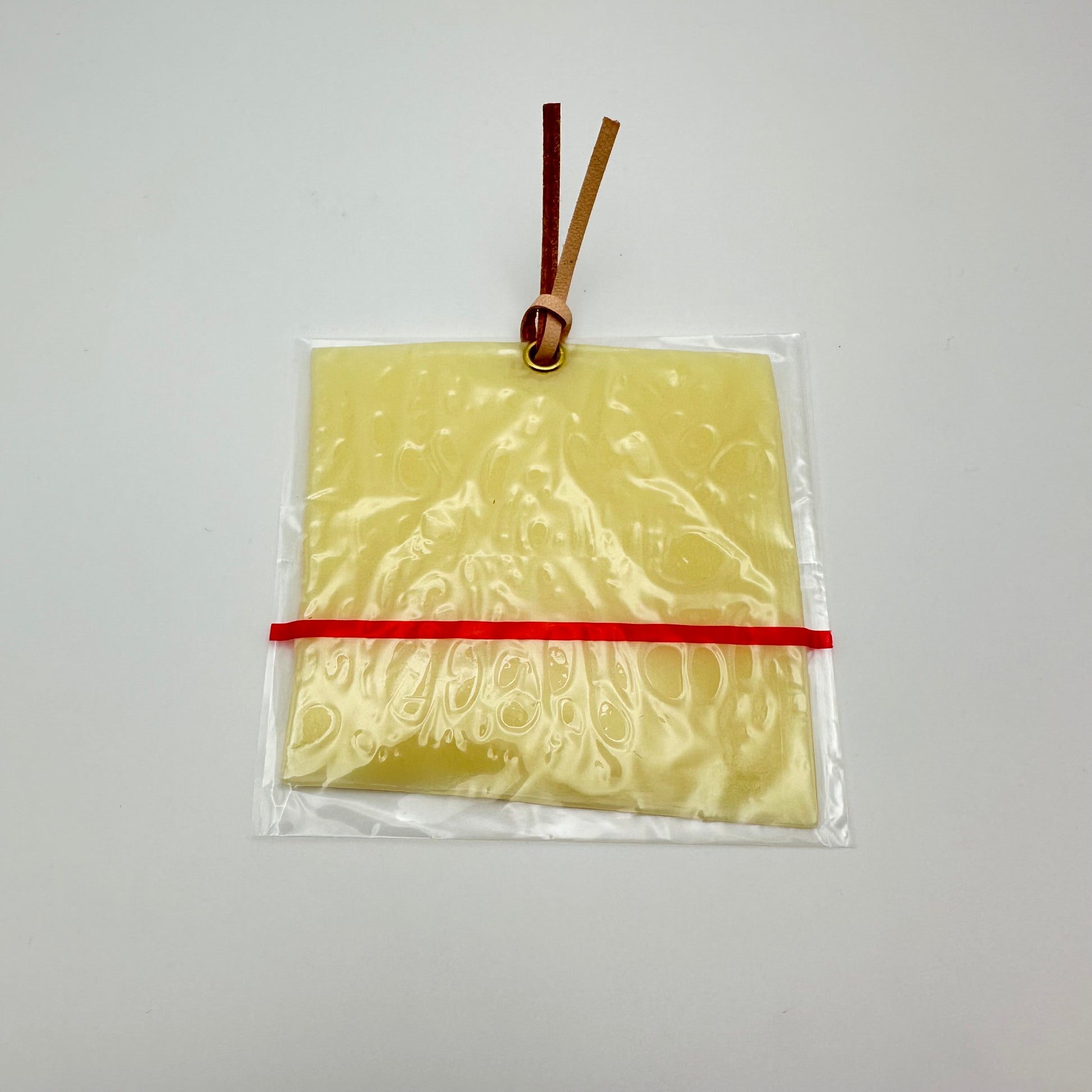 bookmark that looks like an individually wrapped slice of cheese.  Complete with gromit and leather strap 
