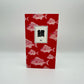 Red notebook with red fish on the cover. Box in the middle with Japanese characters for the word TAI which is the fish on the cover.