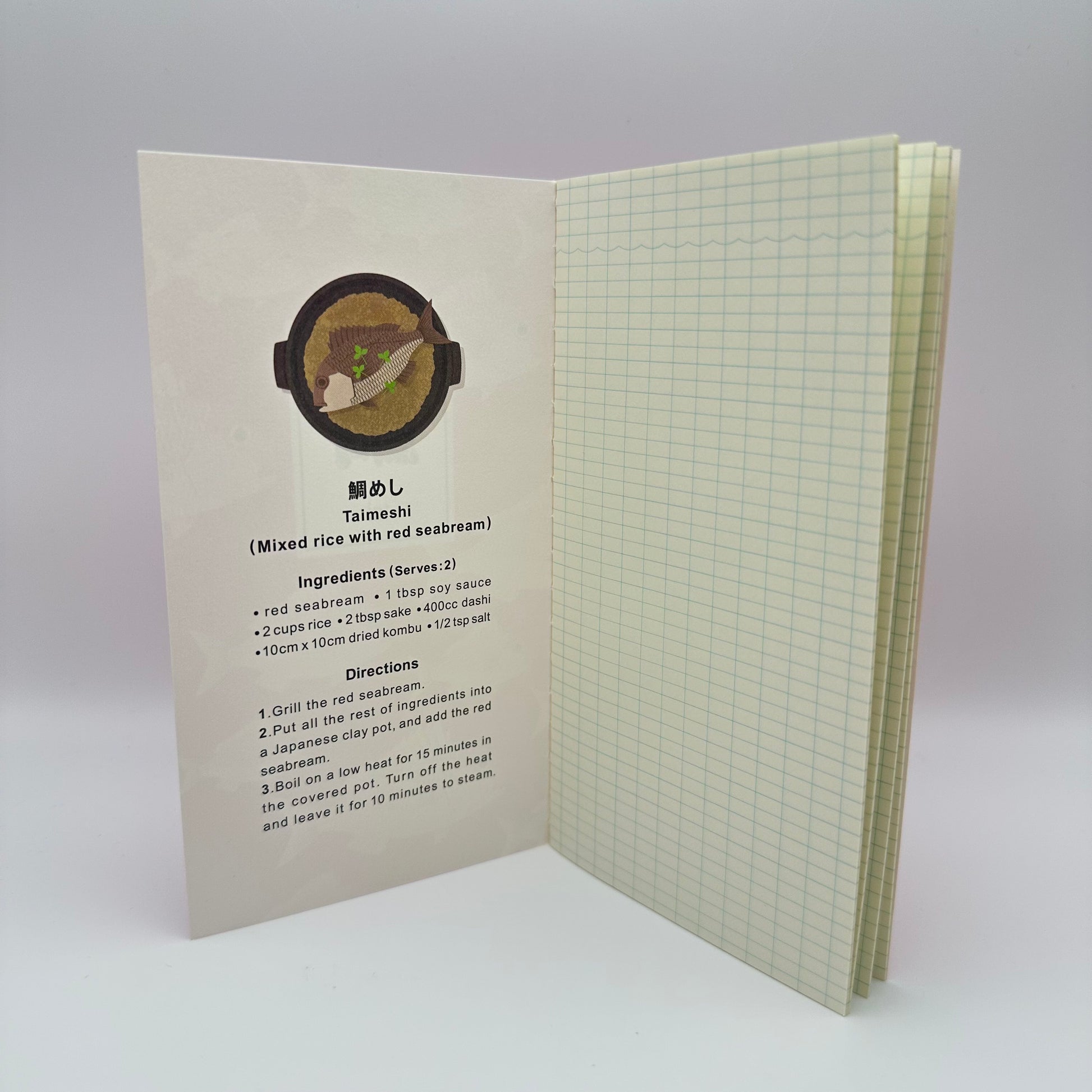 Notebook open to reveal the inside cover which shows a recipe using red seabream fish. The pages are grid.