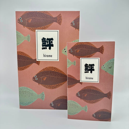 Mauve notebook with teal and brown flounder swimming. Japanese words that read "hirame."Small and large notebook next to eachother.