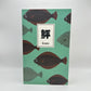 Teal notebook with brown and green flounder swimming on the cover. Japanese text box that reads Hirame.