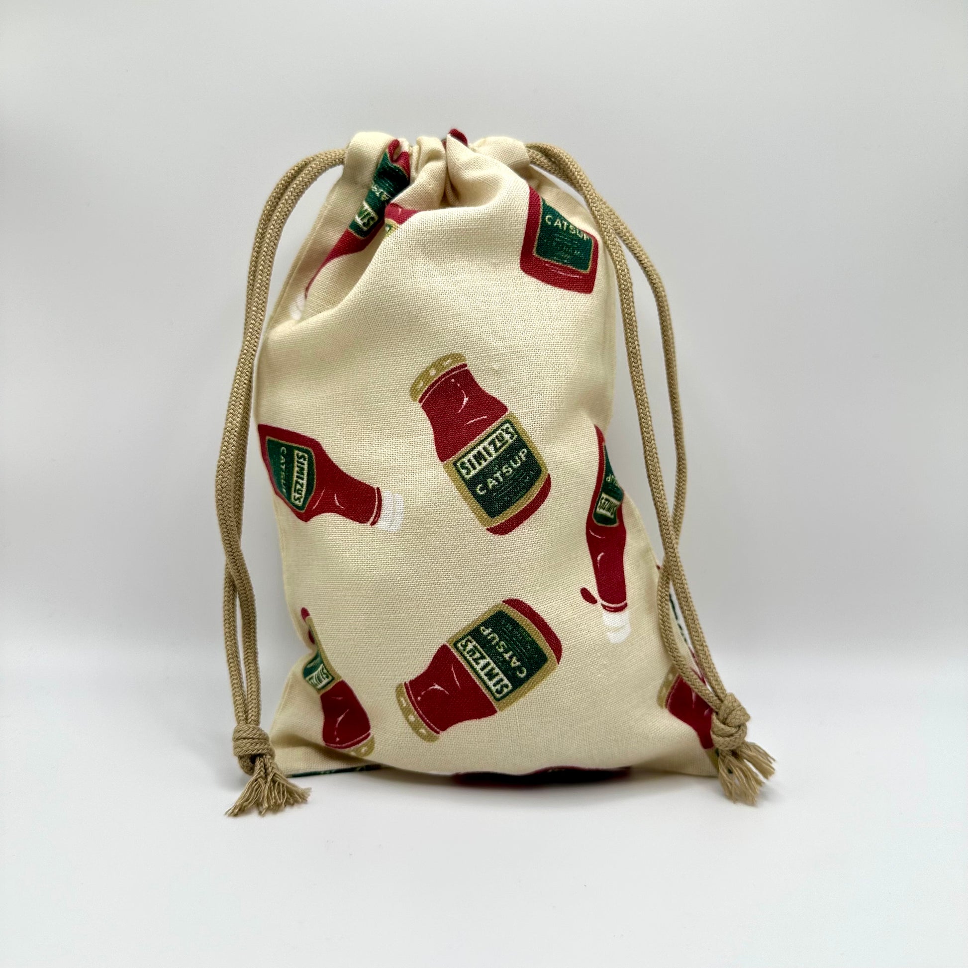 Drawstring pouch with assorted catsup bottles all over it.  