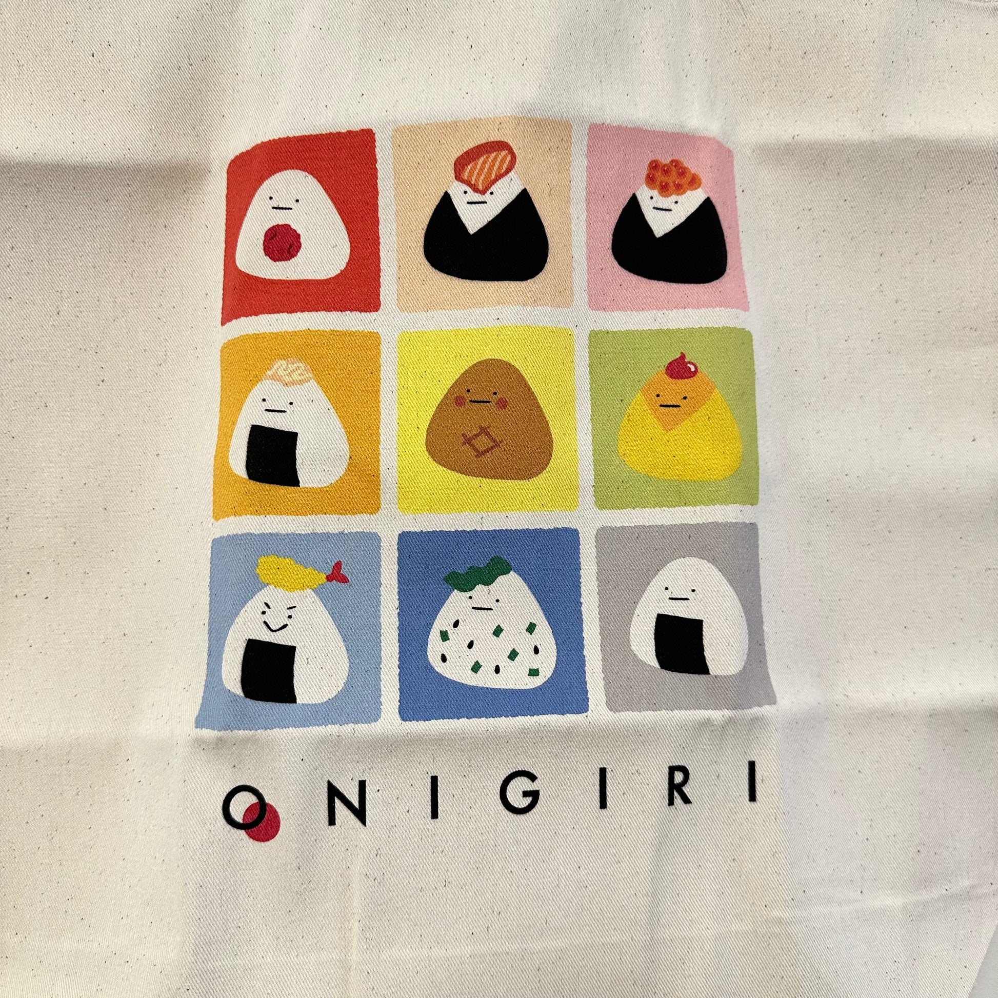 Onigir tote bag with 9 different tiles featuring different flavors of onigiri. 