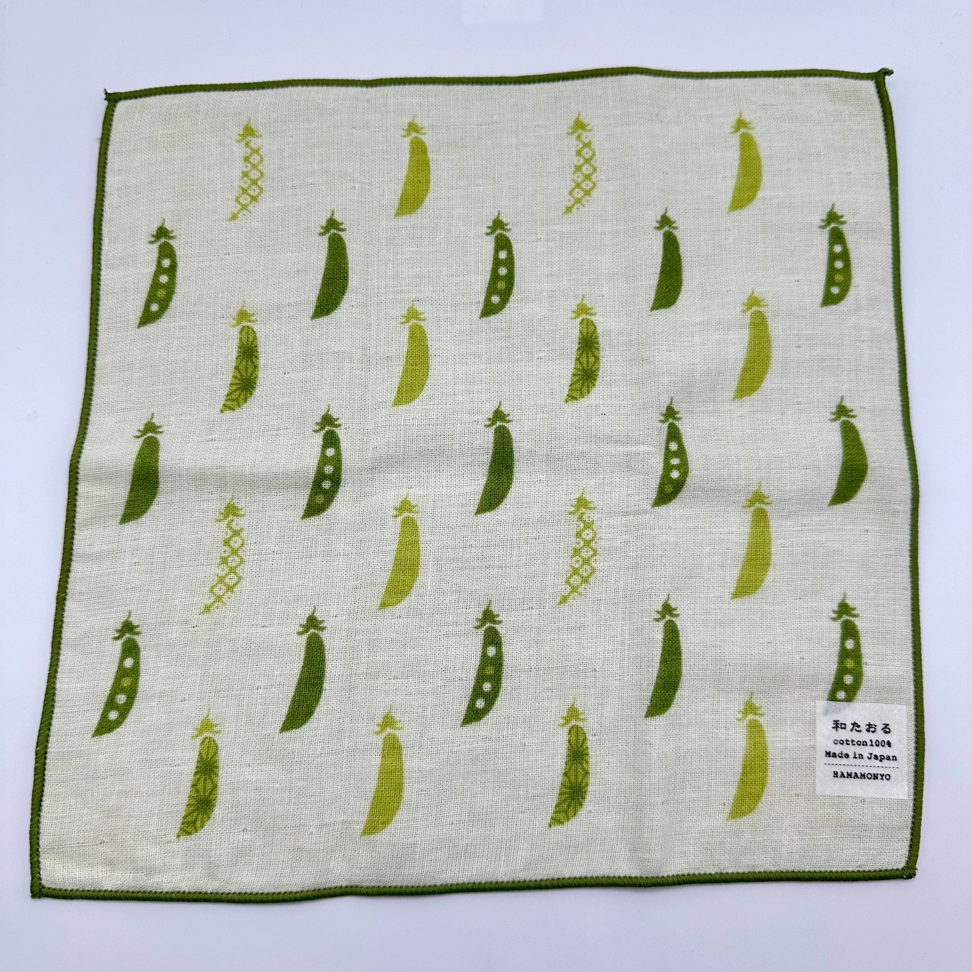 Hand towel with assorted peas in a pod.