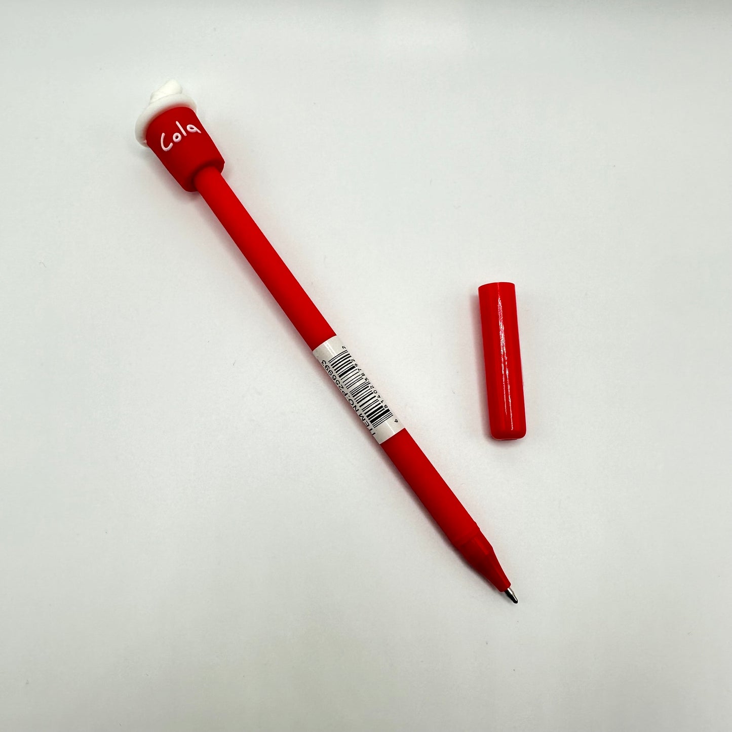 Cola pen with the cap off.