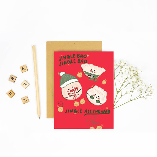 Red greeting card with cartoon buns and festive text, placed on a white background with decorative elements.