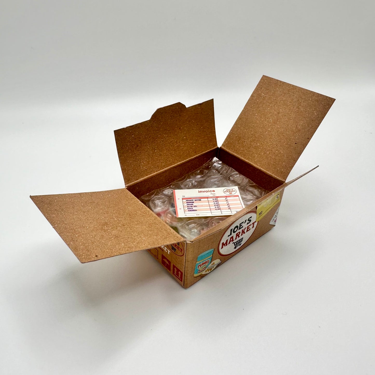 LIttle sticker box open to reveal a sticker that looks like an invoice.