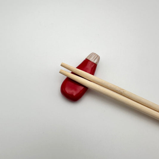 Ketchup Chopstick Rest with chopsticks resting on them.