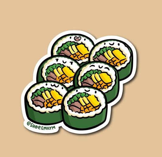 A die-cut sticker featuring six cartoon cut kimbap rolls arranged in a cluster on a warm beige background. The sticker has a white border and includes the handle @SHOPEMILY in green text near the bottom left.