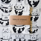 Cotton tea towel with black and white cat and teacup design, branded 'Badger & Burke'.