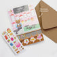 Interactive Card that includes stickers so one can decorate the front of the Sweet Shop with cakes and sweets. Text reads Kitty's Sweet Shop. Kraft envelope and directions that say "Decorate the scene"