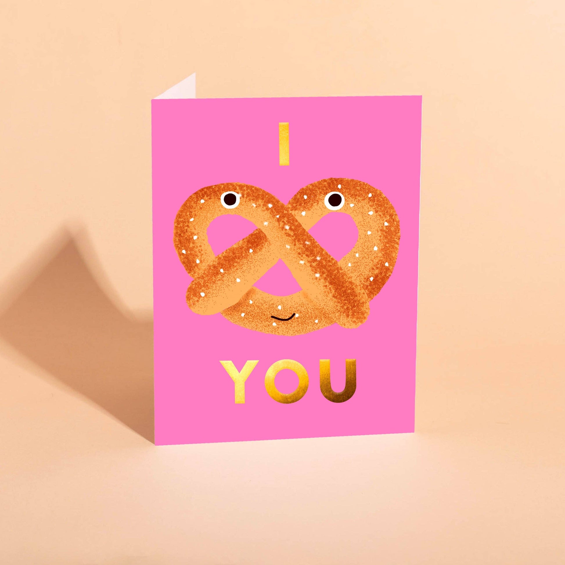 card with a pretzel on it -- above the pretzel is the letter "I" and below it is "you" to say "I <3 you" 