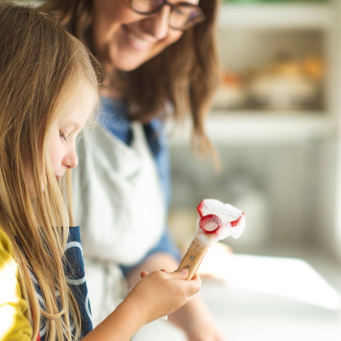 Photo of child and caregiver washing Le Petit Chef tools.