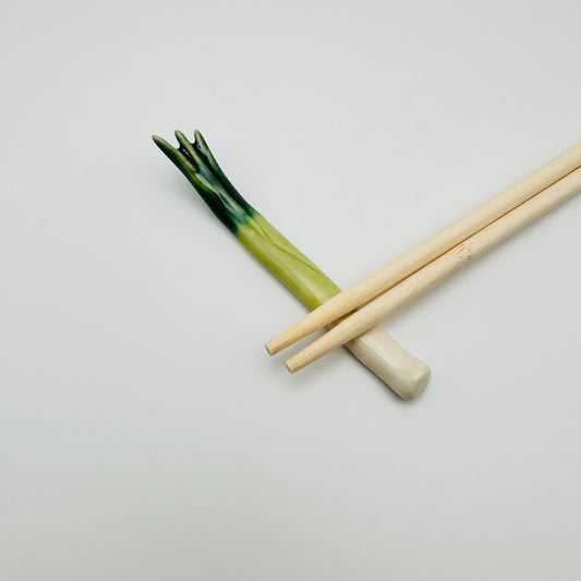 Leek/ Scallion Chopstick Rest with a pair of chopsticks on it.