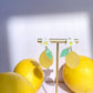 Lemon daisy earrings on jewelry stand 