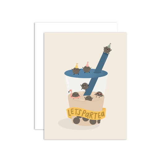 A greeting card featuring a cute illustration of a boba cup with tiny tapioca balls on the lid and straw, and a yellow banner reading 'LET'S PARTY'. A white envelope is placed behind the card on a clean white background.