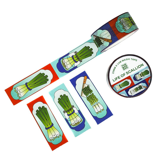 A roll of washi tape and several flat strips featuring illustrated green onions/scallions, shown on a plain white background. The tape has a colorful design with red, blue, teal, and cream sections.