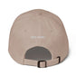 Beige cap with 'kirty studio' embroidered on the back against a white background