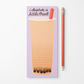 A lavender notepad with a lined bubble tea drawing and the text 'i deserve a little treat' next to a red pencil on a white background.
