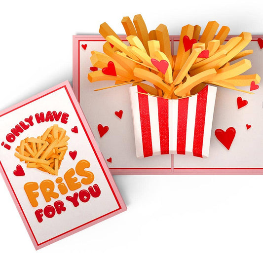 Two cards side by side to show the front of the card that says "I only have fries for you." The inside of the card is a bunch of fries and hearts popping out of of a striped container