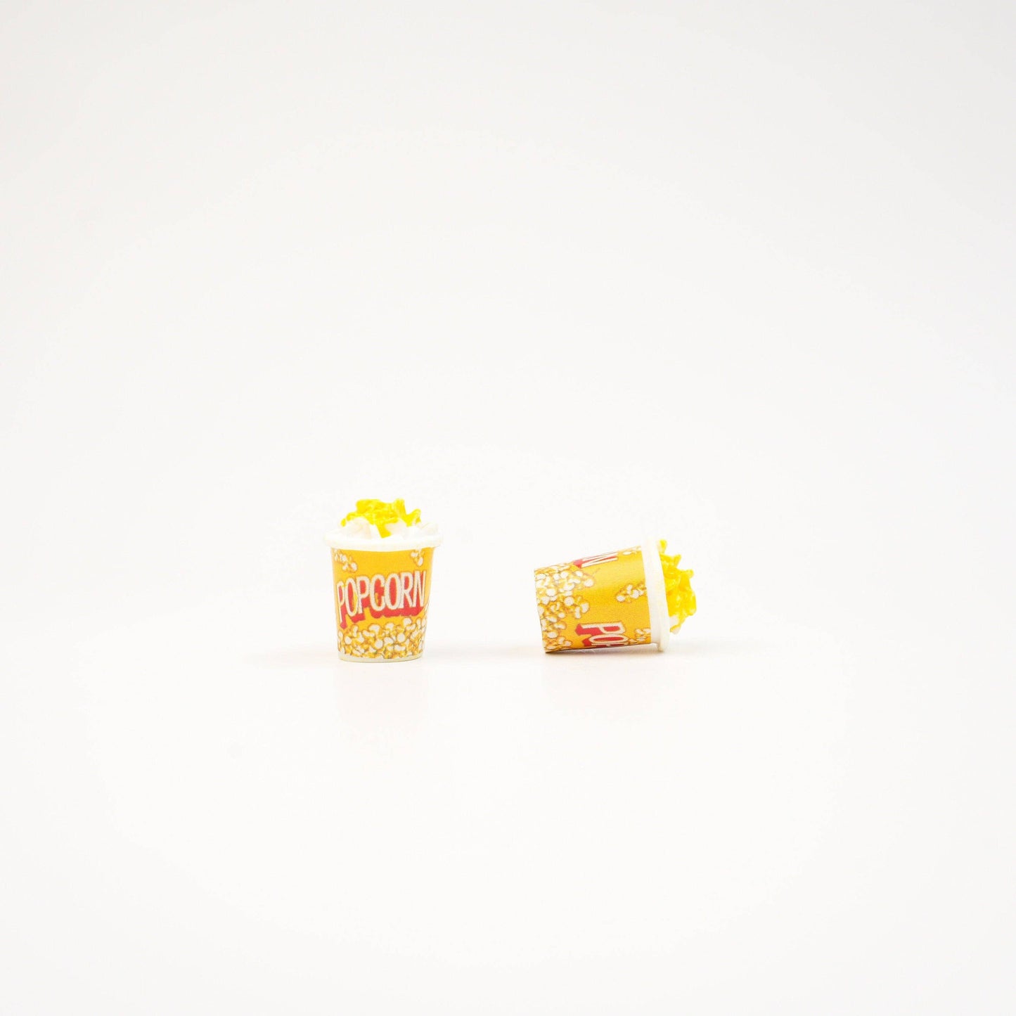 2 popcorn magnets and one is on it's size to show detail