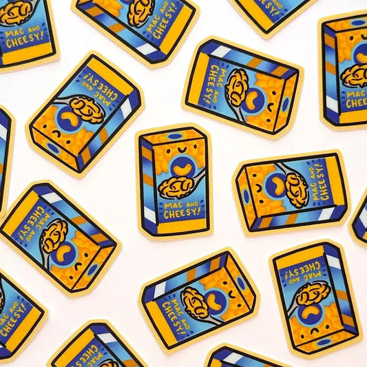 A repeating pattern of illustrated mac and cheese box stickers in bright yellow, blue, and orange on a white background.