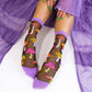 Sheer socks with mushroom pattern worn by a person in a purple outfit.