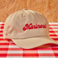 light colored cap with "Marinara!" embroidered in red on the front 