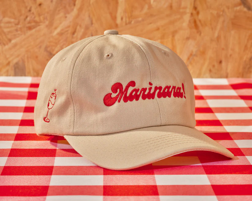 light colored cap with "Marinara!" embroidered in red on the front 