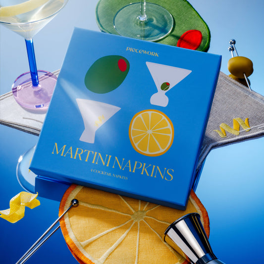 Blue box of Martini Napkins with cocktail-themed design on a blue background with bar accessories.