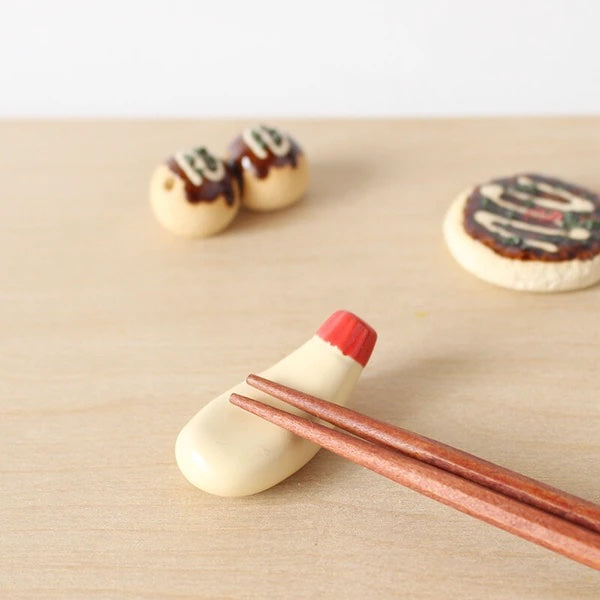 Mini chopstick holder that looks like a Japanese mayo tube.
