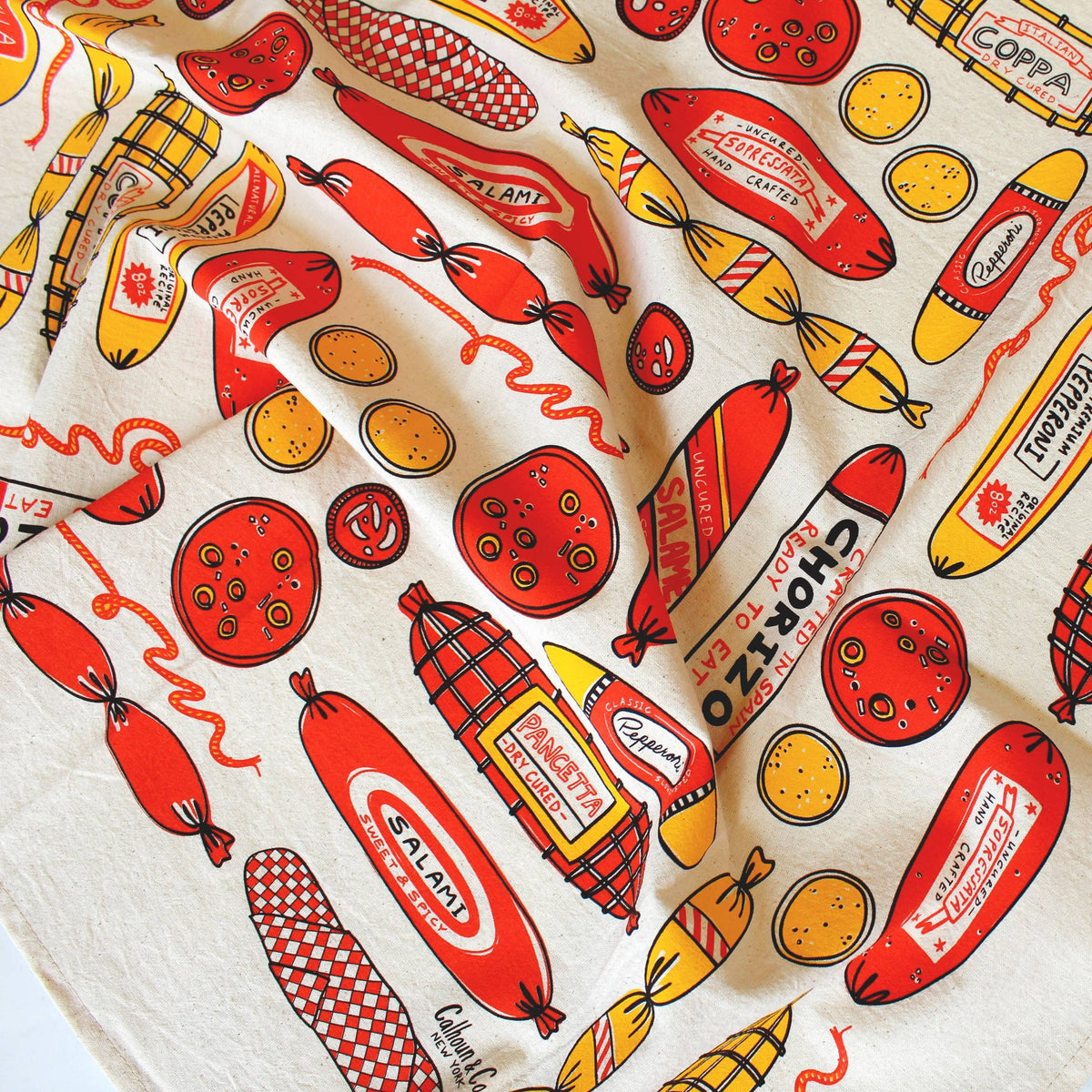 Kitchen towel with assorted meats, salami