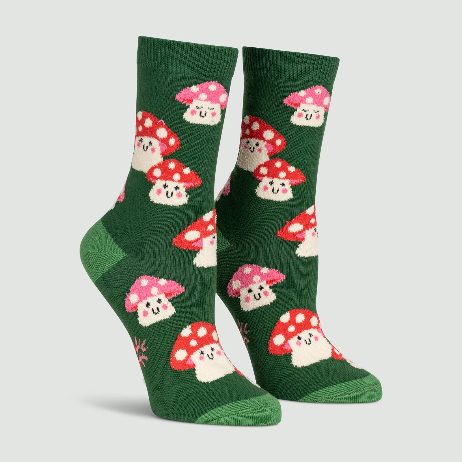 Green stocks with lime green heel and toe. Socks have smiling mushrooms with pink and red spotted caps.